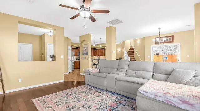 a living room with furniture and wooden floor
