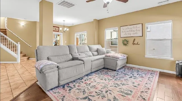 a living room with furniture and a rug