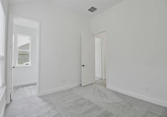 an empty room with closet area