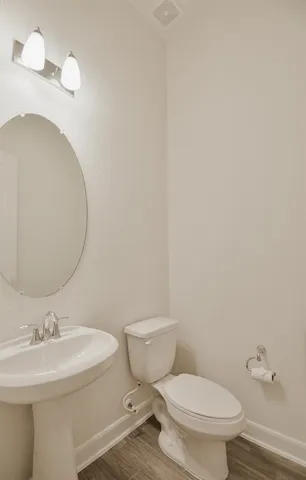 a white toilet sitting next to a bathroom sink
