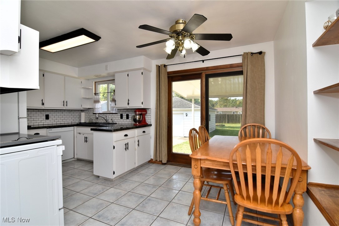 317 Nobottom Road Berea, OH 44017 - Photo 14 of 49 Kitchen with white cabinetry, plenty of natural light, light tile patterned flooring, and decorative backsplash
