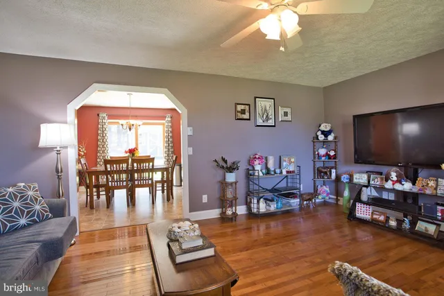 a view of a dining room with furniture wooden floor and chandelier