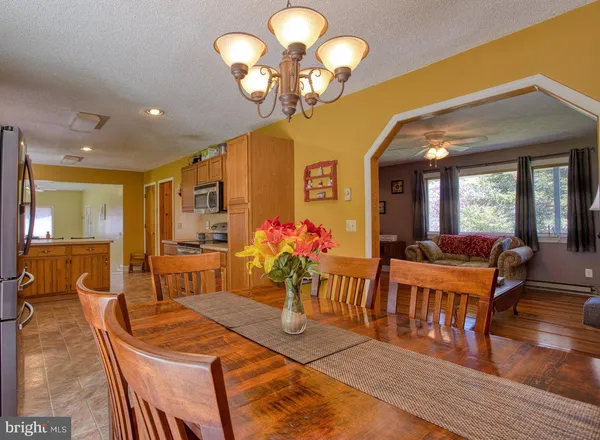 a large kitchen with lots of counter space a sink and chairs