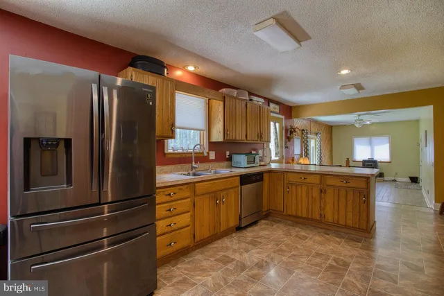 a kitchen with a sink refrigerator and cabinets