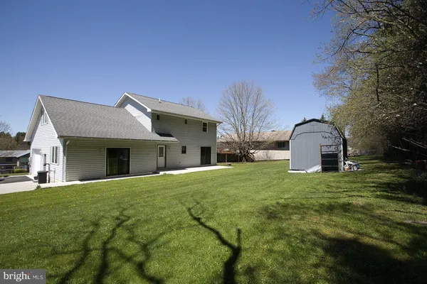 an aerial view of a house with swimming pool and garden