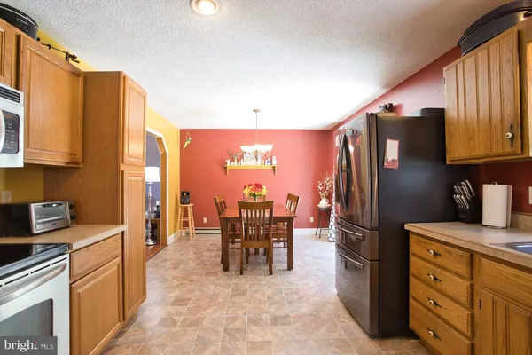 a view of a livingroom with furniture a ceiling fan and window