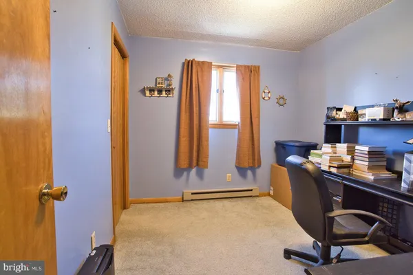 a bathroom with a sink a toilet and shower curtain
