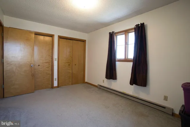 a bedroom with a bed and a mirror