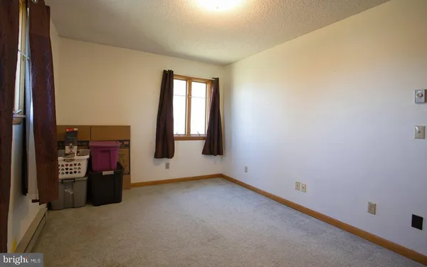 a bedroom with a bed and a mirror