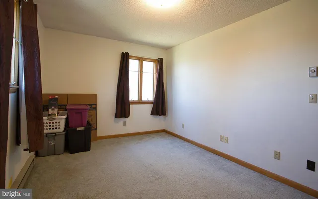 a bedroom with a bed and a mirror