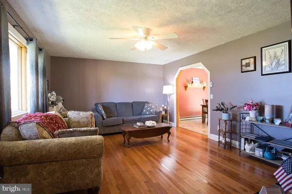 a living room with furniture and a flat screen tv with wooden floor