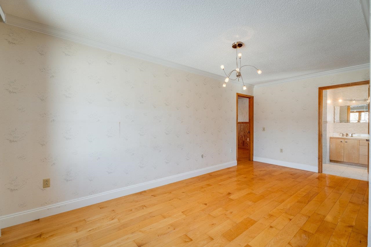 347 Enterprise Road Churchville, VA 24421 - Photo 44 of 75 an empty room with a chandelier fan and wooden floor