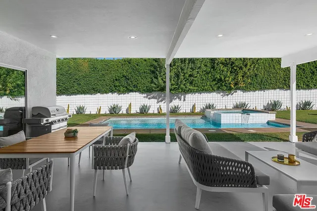 a view of swimming pool and outdoor seating