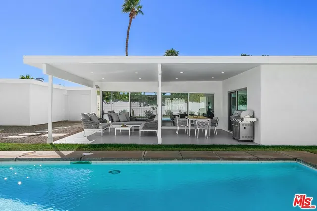 a view of a patio with table and chairs and potted plants