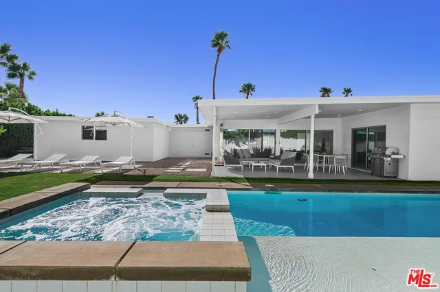 a view of a swimming pool with a yard