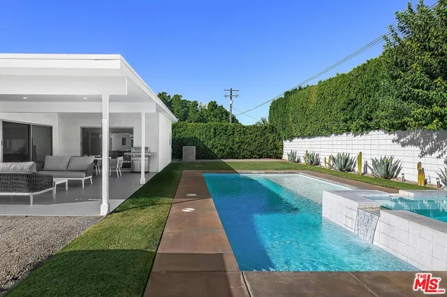 a view of a backyard with sitting area