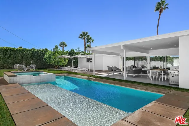 a view of a patio with swimming pool table and chairs