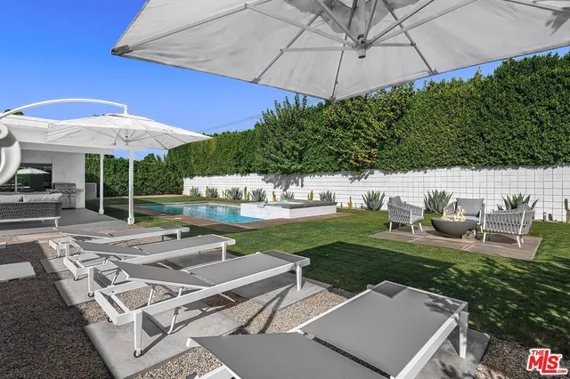 a view of a backyard with sitting area