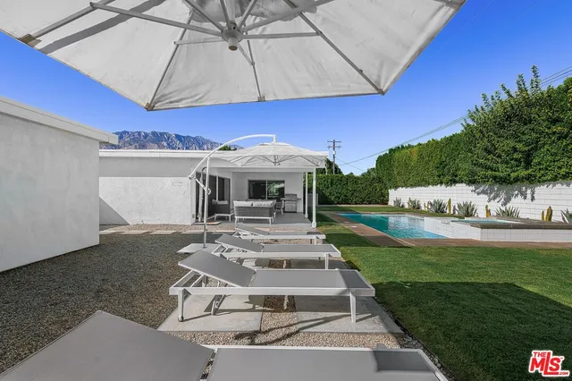 a view of a house with backyard porch and sitting area