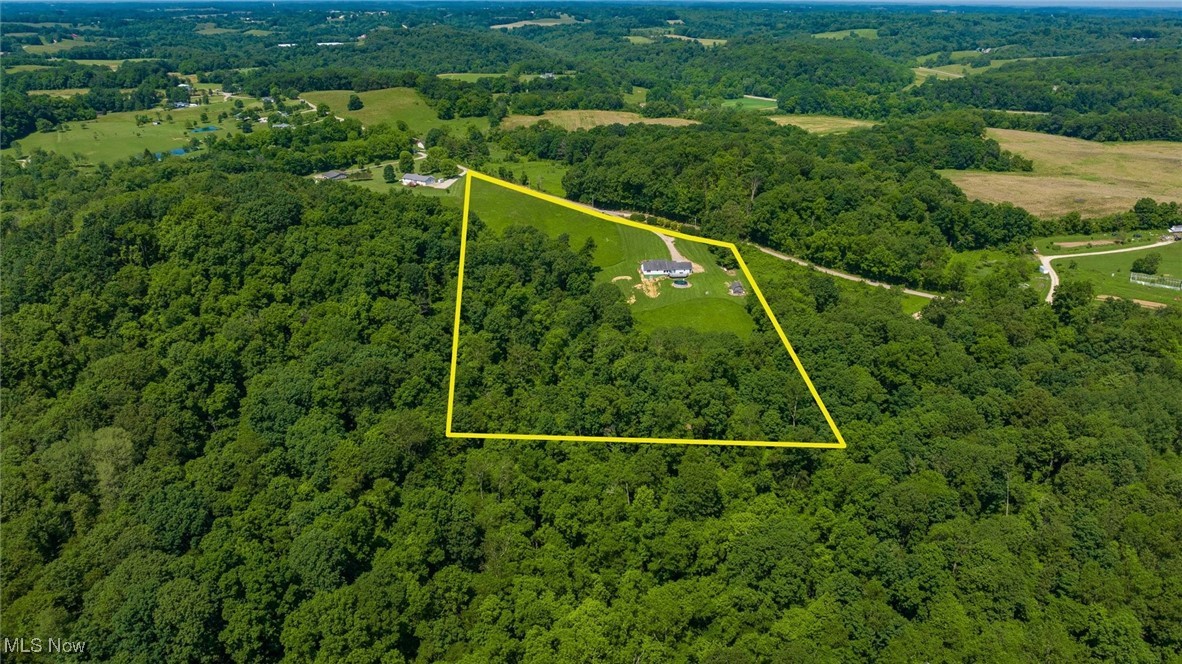 9910 Matchett Road Norwich, OH 43767 - Photo 44 of 48 Aerial view of property and surrounding area featuring a heavily wooded area and property boundaries highlighted