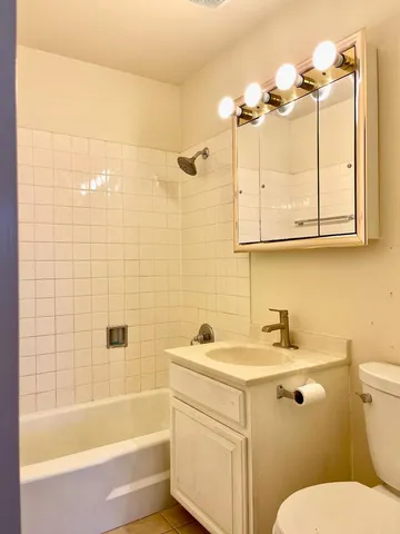 a bathroom with a sink a toilet and bathtub