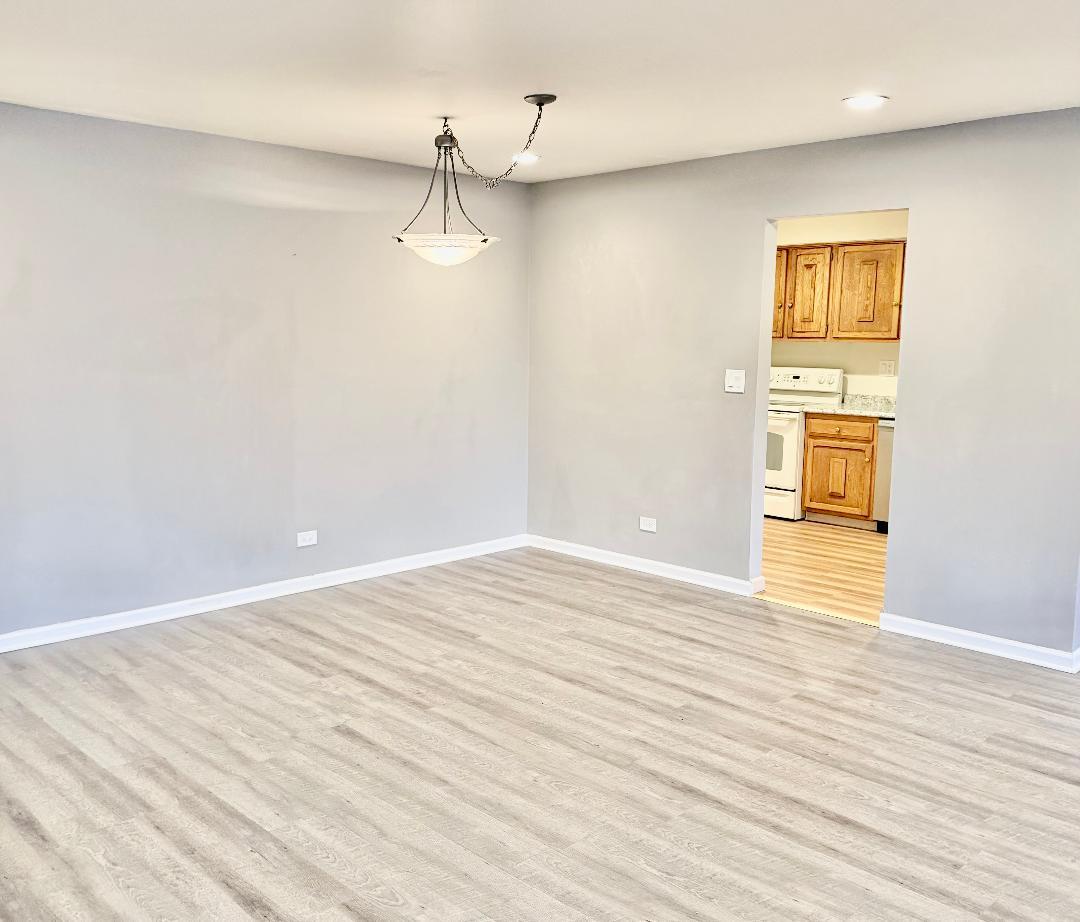 706 East Algonquin Road, Unit 204 Arlington Heights, IL 60005 - Photo 3 of 15 a view of empty room with wooden floor