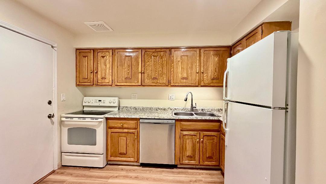 706 East Algonquin Road, Unit 204 Arlington Heights, IL 60005 - Photo 7 of 15 a white refrigerator freezer sitting inside of a kitchen