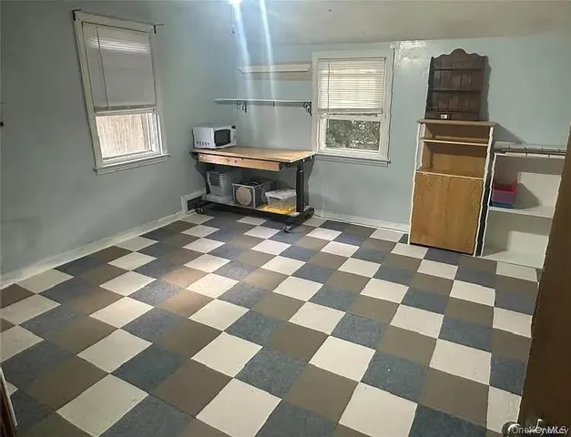 a kitchen with a checkered floor and a black white checkered floor