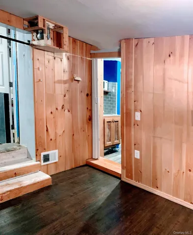 a view of front door with wooden floor