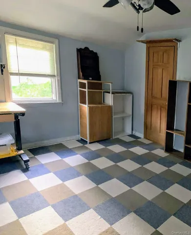a living room with a gaming machine and a rug