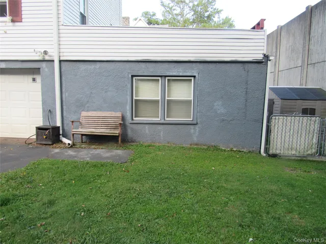 a backyard of a house with barbeque oven