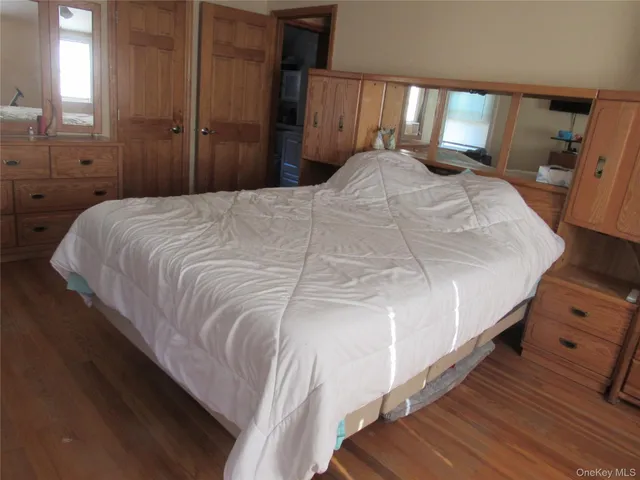 a large white bed in a small room