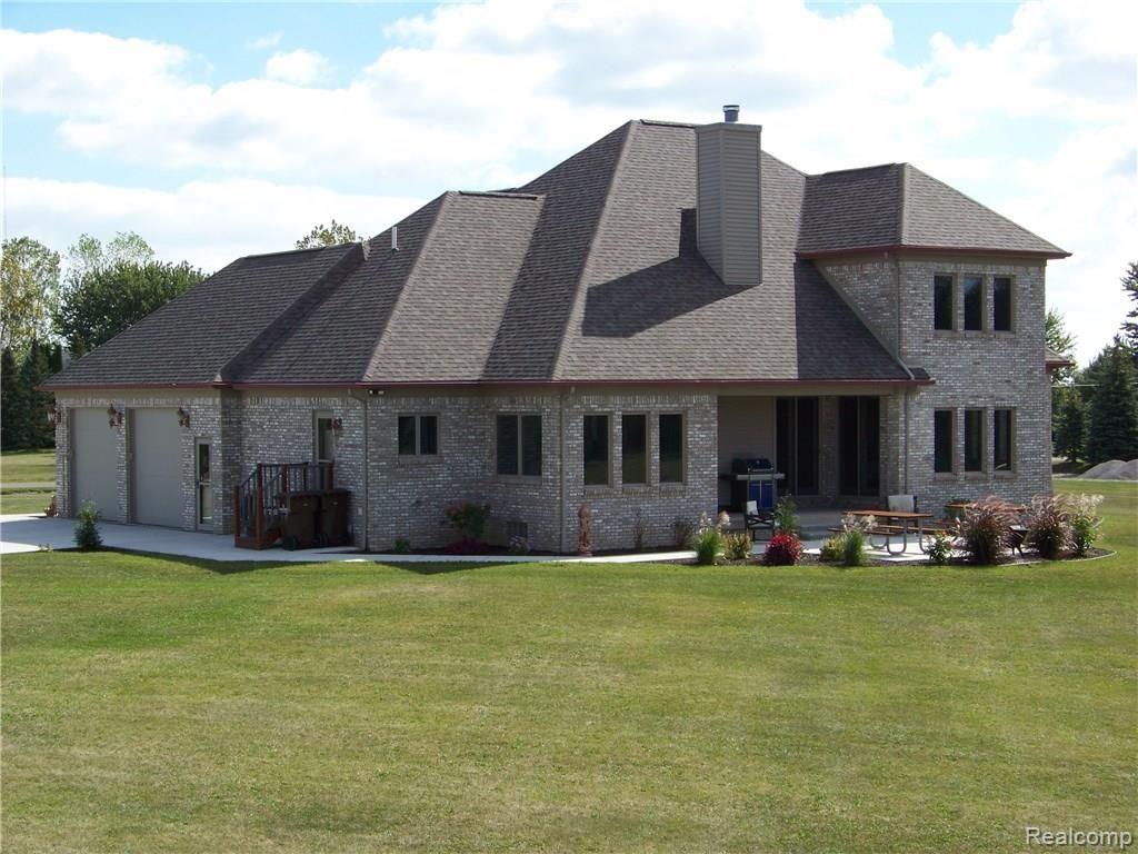 Rear view with covered patio and new exterior patio with walkways. 
