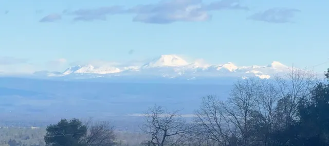 a view of mountain and a yard