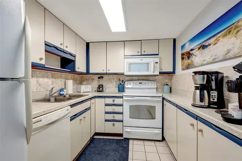 a kitchen with cabinets stainless steel appliances and sink