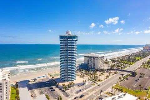 a swimming pool with outdoor seating and city view