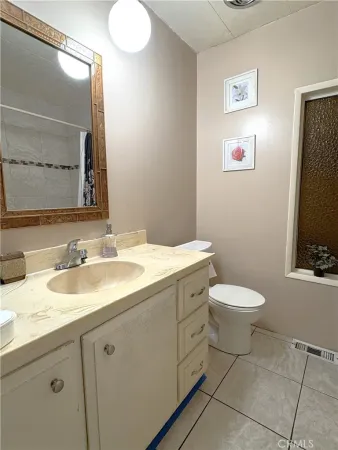 a bathroom with a toilet sink and mirror