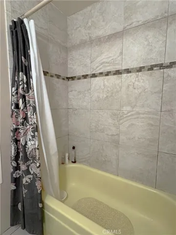 a bathroom with a bathtub and shower