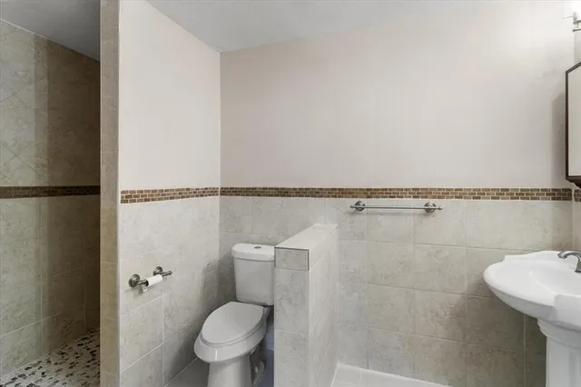 a bathroom with a toilet and a shower