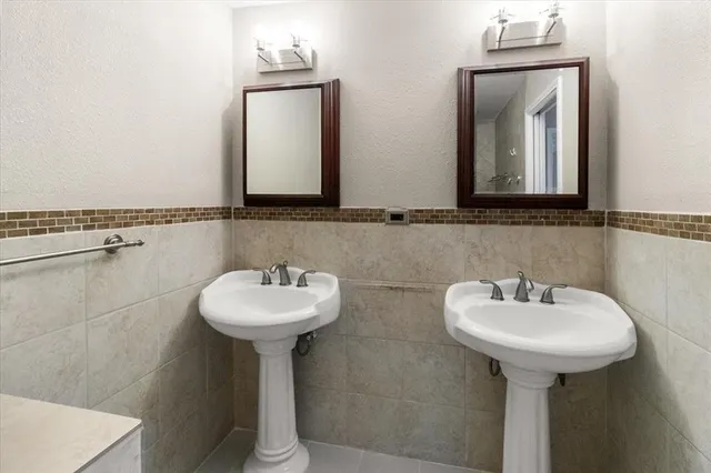 a bathroom with a sink a mirror and shower