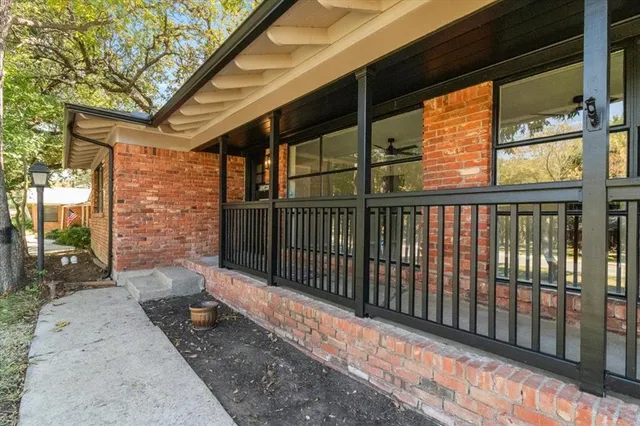 a view of a porch with wooden floor and iron fence