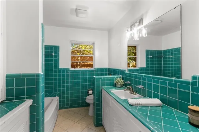 a bathroom with a sink mirror toilet and shower