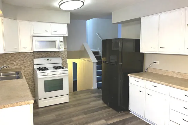a kitchen with a refrigerator sink and stove