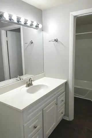 a bathroom with a sink double vanity and a mirror