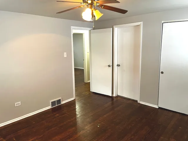 an empty room with wooden floor and door