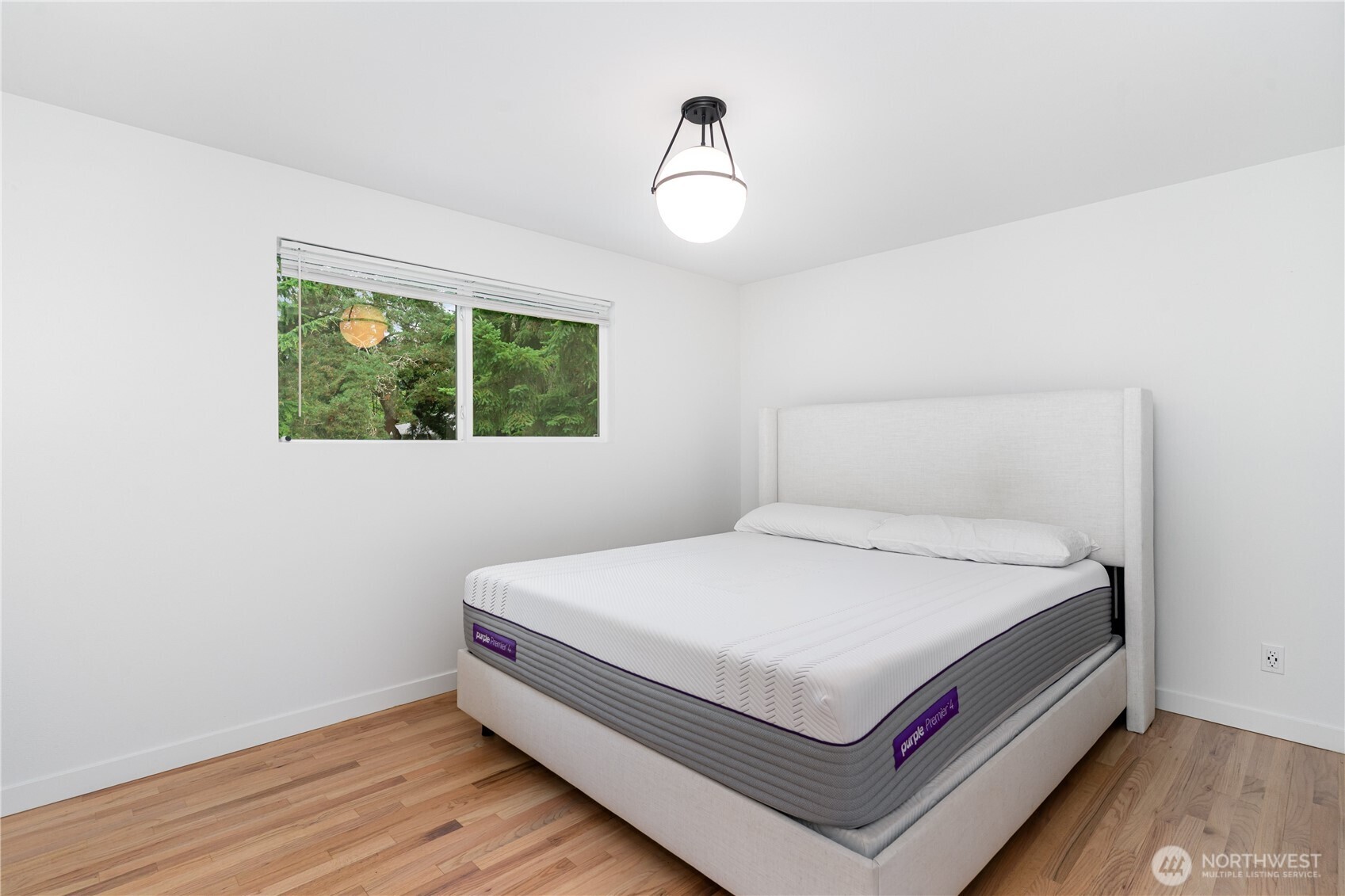 8428 Northeast 132nd Place Kirkland, WA 98034 - Photo 16 of 30 a bed sitting in a bedroom next to a window