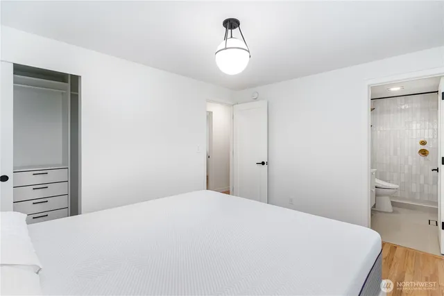 a bedroom with a bed and cabinets