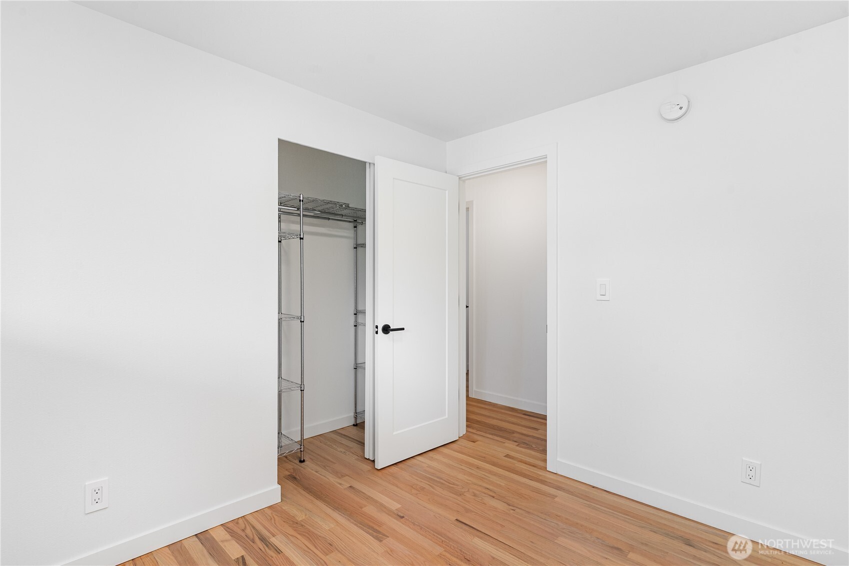 8428 Northeast 132nd Place Kirkland, WA 98034 - Photo 19 of 30 a view of an empty room with wooden floor and closet