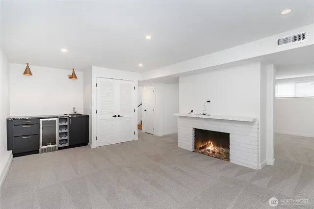 an empty room with furniture and a fireplace