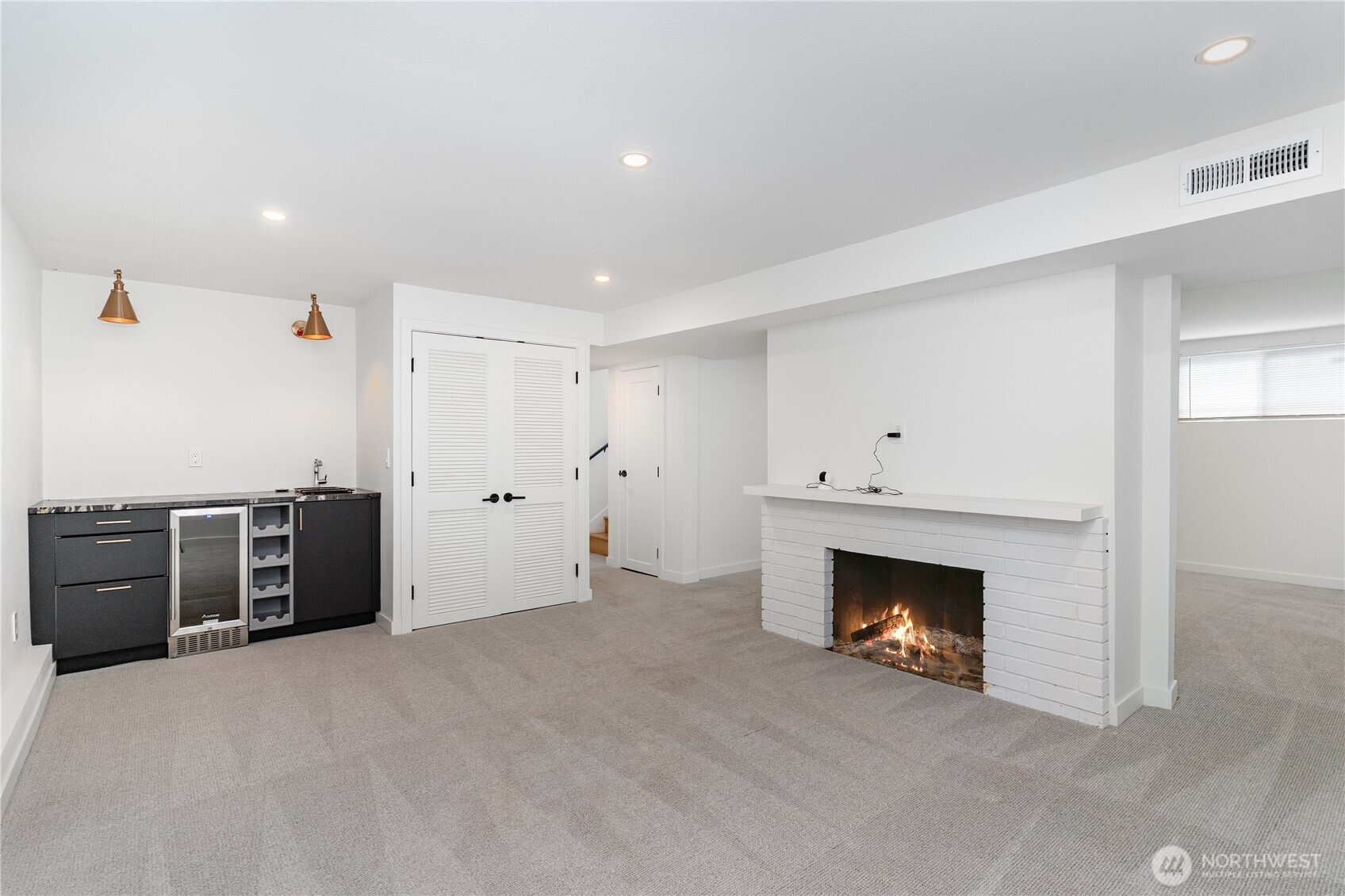 8428 Northeast 132nd Place Kirkland, WA 98034 - Photo 23 of 30 an empty room with furniture and a fireplace